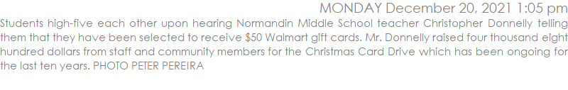 Students high-five each other upon hearing Normandin Middle School teacher Christopher Donnelly telling them that they have been selected to receive $50 Walmart gift cards. Mr. Donnelly raised four thousand eight hundred dollars from staff and community members for the Christmas Card Drive which has been ongoing for the last ten years. PHOTO PETER PEREIRA