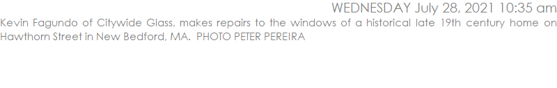 Kevin Fagundo of Citywide Glass, makes repairs to the windows of a historical late 19th century home on Hawthorn Street in New Bedford, MA.  PHOTO PETER PEREIRA