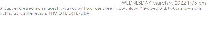 A dapper dressed man makes his way down Purchase Street in downtown New Bedford, MA as snow starts fralling across the region.  PHOTO PETER PEREIRA