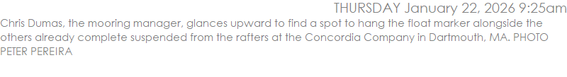 Chris Dumas, the mooring manager, glances upward to find a spot to hang the float marker alongside the others already complete suspended from the rafters at the Concordia Company in Dartmouth, MA. PHOTO PETER PEREIRA