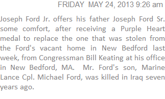 Joseph Ford Jr. offers his father Joseph Ford Sr. some comfort after receiving a Purple Heart medal to replace the one that was stolen from the Ford's vacant home in New Bedford last week from Congressman Bill Keating at his office in New Bedford, MA.  Mr. Ford's son, Marine Lance Cpl. Michael Ford, was killed in Iraq seven years ago