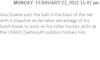 Gus Duarte puts the ball in the back of the net with a slapshot as he takes advantage of his lunch break to work on his roller hockey skills at the UMASS Dartmouth outdoor hockey rink.