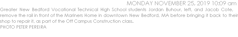 Greater New Bedford Vocational Technical High School students Jordan Buhour, left, and Jacob Cote,   remove the rail in front of the Mariners Home in downtown New Bedford, MA before bringing it back to their shop to repair it, as part of the Off Campus Construction class. 