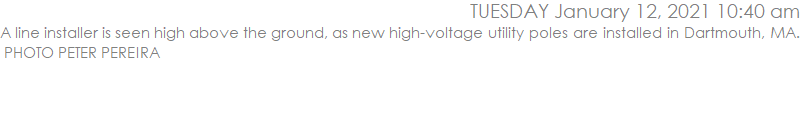 A line installer is seen high above the ground, as new high-voltage utility poles are installed in Dartmouth, MA.  PHOTO PETER PEREIRA