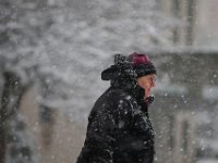 A woman makes her way down School Street in New Bedford as snow falls across the region. PHOTOS PETER PEREIRA