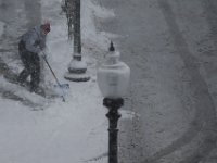 A man sweeps the sidewalk on Middle Street in New Bedford as snow falls across the region. PHOTOS PETER PEREIRA