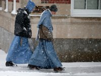 Two Franciscan friars make their way up Pleasant Street in downtown New Bedford as snow falls across the region. PHOTOS PETER PEREIRA