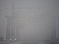 A taxi cab is barely visible as it makes it's way across the Fairhaven bridge as a snowstorm sweeps across the region. PHOTOS PETER PEREIRA