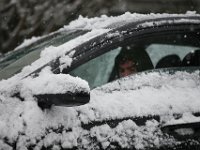 A man is seen inside his vehicle parked on South Street in Fairhaven as snow falls across the region. PHOTOS PETER PEREIRA