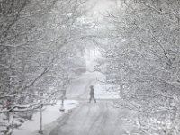 A woman crosses Middle Street in New Bedford as a snowstorm sweeps across the region. PHOTOS PETER PEREIRA