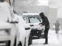 A man opens the door to his car parked in Fairhaven as heavy snow falls across the region. PHOTOS PETER PEREIRA