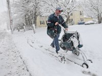 Postman Josh Ashley fights the driving snow and cold weather, as he make his way up Main Street in Fairhaven using a cart to deliver mail during the first snowstorm of the year. PHOTOS PETER PEREIRA