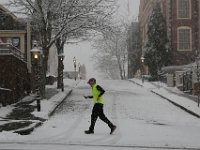 A man runs up Union Street past Jonny Cake Hill in downtown New Bedford during the years first snowstorm. PHOTOS PETER PEREIRA