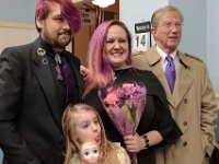 The date of February 14th peeks out from the background, as Kelly Hayden, her father, Jim Hayden, her groom David McDonough and her daughter, Bella Rose, take a photo inside of the City Clerk's office in New Bedford City Hall before being married on Valentine's Day. PHOTO PETER PEREIRA