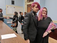 Kelly Hayden and David McDonough embrace inside of the City Clerk's office in New Bedford City Hall, while in the background another couple arrive to be married as well on Valentine's Day. PHOTO PETER PEREIRA