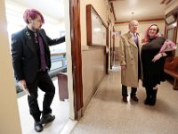 David McDonough looks on as his new bride, Kelly Hayden, and her father, Jim Hayden, embrace in the corridor of New Bedford City Hall, before the couple is wed on Valentine's Day. PHOTO PETER PEREIRA