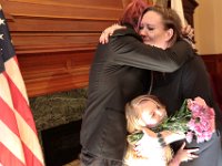 Newlyweds David McDonough and Kelly Hayden are joined by Kelly's daughter, Bella Rose, in a group embrace, after the couple were married on Valentine's Day at New Bedford City Hall.   PHOTO PETER PEREIRA