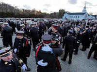 Firefighters seek comfort in each other as they and fellow firefighters from across two states line up out side of the Hathaway Community Home for Funerals in Somerset, for the wake of Somerset Fire Chief Scott Jepson.  [ PETER PEREIRA/THE STANDARD-TIMES/SCMG ]