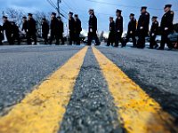 Firefighters from across two states walk across Buffington Street in Somerset, making their way to the Community Home for Funerals in Somerset, for the wake of Somerset Fire Chief Scott Jepson.  [ PETER PEREIRA/THE STANDARD-TIMES/SCMG ]