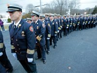 New Bedford acting deputy chief Scott Kruger, left, is joined by firefighters from across two states in a ine outside of the Hathaway Community Home for Funerals in Somerset, for the wake of Somerset Fire Chief Scott Jepson.  [ PETER PEREIRA/THE STANDARD-TIMES/SCMG ]