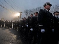 Snow starts to fall, as firefighters wait in line outside of the Hathaway Community Home for Funerals in Somerset, for the wake of Somerset Fire Chief Scott Jepson.  [ PETER PEREIRA/THE STANDARD-TIMES/SCMG ]