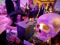 A witch signs in upon arriving at the second Annual Whaling City Witches' Ball held at the Tryworks Auditorium of the First Unitarian Church building in downtown New Bedford.  PHOTO PETER PEREIRA