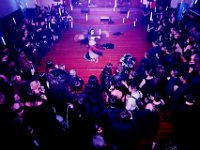 Guests look on Madame Ceridwyn belly dances and twirls under the suspended candle lights at the second Annual Whaling City Witches' Ball held at the Tryworks Auditorium of the First Unitarian Church building in downtown New Bedford.    PHOTO PETER PEREIRA