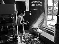 A woman and young girl wait for a man to finish making his purchases at New Bedford Ship Supply before he heads out to sea from New Bedford harbor.