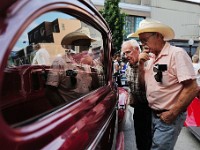 Two men take a closer look at one of the many vintage cars on display at the annual Joe Jesus' 50s Night in downtown New Bedford.