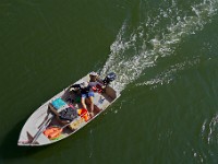 A man rides his boat as seen from the Route 88 bridge over the Westport River.