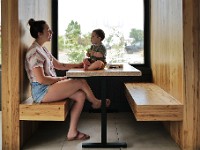 Lexi Malloy and her one year old son, Connolly Malloy, enjoy a moment together in one of the booths of Ground Floor Coffee in New Bedford.