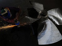 John DeMello, propeller technician at Scandia in Fairhaven, sends sparks flying as he makes repairs to a stainless steel propeller from a fishing boat.