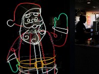 A neon Santa welcomes guests to Ground Floor Coffee in New Bedford as Cole River takes an order inside the waterfront cafe.