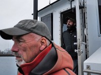 Bob Bower, left and Alvaro Salvador, owner, keep their eyes on other boats crossing the harbor as they make their way aboard the the Bay Fuels re-fueling barge to bring petrol to a scalloper docked in New Bedford