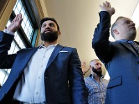 (l to r) Samarth Patel, India, Goce Jankovski, North Macedonia and Jonathan Wcislo, Scotland, pledge the Oath of Allegiance during a naturalization ceremony held at the Immigrants' Assistance Center in New Bedford where twenty-three people from fifteen countries became United States citizens.