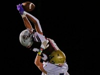 Stang wide receiver Try Gonsalves Cosme elevates for the catch as Archbishop Williams' Devin Sheehan makes the defensive play during Bishop Stang High School's win at home against Archbishop Williams High School.