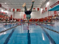 Apponequet's Levi Jope enters the water before winning the 100 meter freestyle race during New Bedford High School swim meet against Apponequet High School in New Bedford.