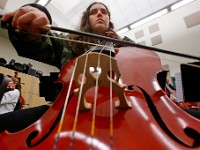 Dartmouth High School orchestra celloist, Cynthia Scott, 17, practices a composition written by Soon Hee Newbold, who is visiting their school.