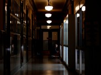 A man stops to browse the glass collection on display on the first floor of New Bedford City Hall.  This is part of a rotating collection housed in the New Bedford Glass Museum.