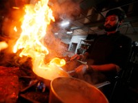 Ritesh Vaze sends flames into the air as he prepares various dressing in the kitchen of the newly opened Safron by the Sea in Fairhaven.