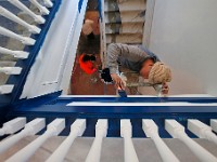 Painters put the final touches on the stairwell at the former Holy Family High School building which has been converted into housing.