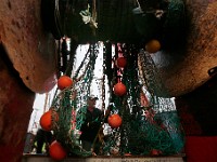 Luis Rios mends the nets aboard the fishing boat Fisherman before heading back out to sea from New Bedford.