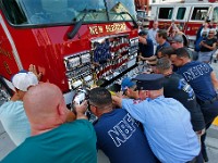 New Bedford firefighters push the new Engine 8 fire apparatus into the garage as part of a ceremony steeped in tradition.  The new $750,000 fire truck replaces the 16-year-old previous Engine 8, seen in background, at Station 8 on Acushnet Avenue in New Bedford.