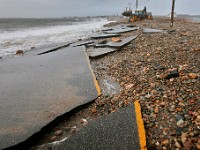 The remnants of East Beach Road in Westport are seen in the foreground after heavy overnight winds and surf battered the coastline.