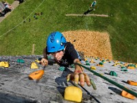 Dartmouth Middle School eighth grader, Austin Backlund, 14, reaches for a hand hold as he climbs the 40' wall during a field trip to the Dartmouth YMCA.