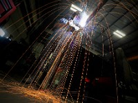 Dave Mazzotti, fabricator, sends sparks flying as he makes fabricates a metal rod to be used in conjunction with a fishing boat's scallop dredge, at the Reidar's Manufacturing building on Tarkiln Place in New Bedford