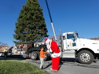 Kyrin DePina, 4, walks over to shake Santa's hand, as New Bedford Highway Department and Greenspace crews cut the tree across the street from his house, before trainsporting it to its final location in front of the Public Library downtown where it will become the official New Bedford Christmas tree.