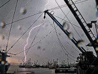 Lightning strikes fall on fishing boats docked in New Bedford, MA on May 23, 2024 as a storm rolls over the region.