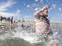 Tyler O'Driscoll sends water flying into the air as he and fellow participants jump into the cold waters off Gooseberry Island in Westport during the annual Plunge of the Faithful.  The event is held in memory of Shannon O'Driscoll who was killed in 2006 by an SUV driver while holding a sign supporting organized day care programs in the state. This is part of a fundraiser, which has raised over 20K dollars since it began.