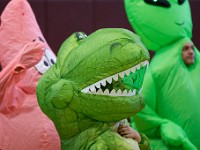 Roosevelt Middle School math teacher, Rylee Gonsalves, tries to see out of her dino suit before running against fellow teachers during the school's annual rally before the holiday season.